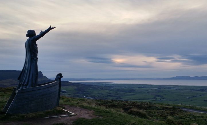 A statue of Manannán mac Lir, who stands tall and strong in the prow of a boat, his arms outstretched, overlooking the North Atlantic